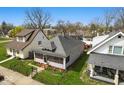 Lovely single-story home with a quaint screened porch and a well-kept lawn, surrounded by trees at 1114 N Mount St, Indianapolis, IN 46222