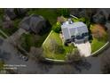 An aerial view showcases a home with a well-manicured lawn and a patio at 12011 Glen Cove Dr, Indianapolis, IN 46236