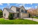 Charming two-story home featuring a two-car garage and mature trees at 12011 Glen Cove Dr, Indianapolis, IN 46236