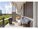 Inviting porch with comfortable seating and decorative accents, perfect for relaxing outdoors at 1230 Amberley Way, Westfield, IN 46074