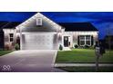 Inviting home exterior with manicured lawn, brick accents and tasteful lighting for enhanced curb appeal at 1239 Northcraft Ct, Franklin, IN 46131