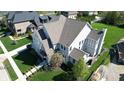 An aerial view of a well-maintained property showcasing the roof, lawn, and surrounding neighborhood at 12725 Parsons Gate, Carmel, IN 46032