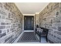 Inviting entryway features stone walls, a stylish front door, bench, and tasteful decor at 12725 Parsons Gate, Carmel, IN 46032