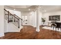Bright entryway with hardwood floors, staircase with detailed railing, and modern decor at 16016 Viking Lair Rd, Westfield, IN 46074