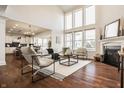 Spacious living room with fireplace, large windows, hardwood floors, and modern decor at 16016 Viking Lair Rd, Westfield, IN 46074