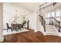 Bright living room and dining area with hardwood floors and staircase to the second floor at 16016 Viking Lair Rd, Westfield, IN 46074
