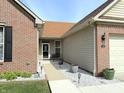 Charming home entrance with brick and siding, featuring a walkway and landscaped yard at 1649 Woodfield Dr, Greenwood, IN 46143