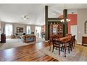 Open-concept living room, dining area, hardwood and carpeted floors, perfect for entertaining at 1649 Woodfield Dr, Greenwood, IN 46143