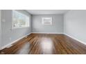 Cozy bedroom featuring hardwood floors, neutral paint and natural light through the window overlooking the yard at 1819 S Drexel Ave, Indianapolis, IN 46203