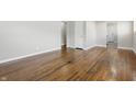 Bright living room showcasing hardwood floors, neutral paint and open layout with seamless flow to the rest of the home at 1819 S Drexel Ave, Indianapolis, IN 46203