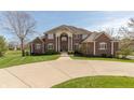 Attractive brick home with a wide driveway, a large lawn, and manicured landscaping, offering great curb appeal at 1937 Knightsbridge Rd, Danville, IN 46122
