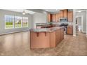 Bright eat-in kitchen featuring an island with seating, tile floors, modern appliances, and ample counter space at 1968 Saratoga Dr, Greenwood, IN 46143
