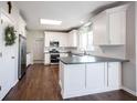 Bright kitchen with white cabinets, stainless steel appliances, and a functional island, ideal for cooking and entertaining at 2261 Mustang Chase Dr, Carmel, IN 46074