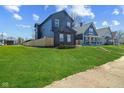 View of exterior of home with long green lawn at 2325 E Brookside Ave, Indianapolis, IN 46218