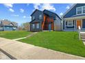 View of exterior of home with long green lawn at 2325 E Brookside Ave, Indianapolis, IN 46218