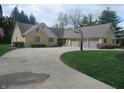 Long circular driveway leading to a three car garage on a well maintained lawn at 2427 Cedar Bend Dr, Anderson, IN 46011