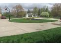Circular driveway with manicured landscaping and view of a well maintained lawn at 2427 Cedar Bend Dr, Anderson, IN 46011