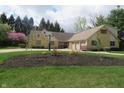 Well-maintained exterior featuring stone accents, manicured lawn, landscaping and basketball hoop at 2427 Cedar Bend Dr, Anderson, IN 46011