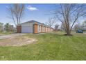 Brick home with a two-car garage and expansive front lawn on a sunny day at 2526 David Dr, Westfield, IN 46074