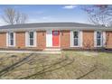 A closer view of the red front door and white-framed windows on this inviting brick home at 2526 David Dr, Westfield, IN 46074