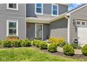 Charming home entrance featuring manicured shrubs and flower boxes under the windows at 272 Van Buren St, Greenfield, IN 46140