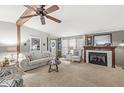 Cozy living room with fireplace, exposed beam, neutral colors, and comfortable seating at 3283 Westpointe Dr, Franklin, IN 46131
