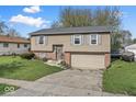 Charming two-story home featuring neutral siding, grey shutters and a two-car garage at 3432 Joan Pl, Indianapolis, IN 46226