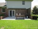 Back patio featuring a sliding door, picnic table, grill, and partial shade structure at 4166 Cobblestone Way, Greenwood, IN 46143