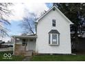 Charming two-story home with a covered porch and a classic white exterior siding at 418 N 14Th St, Elwood, IN 46036