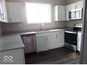 Modern kitchen featuring stainless steel appliances, white cabinets, and granite countertops at 418 N 14Th St, Elwood, IN 46036