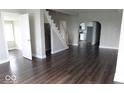 Open-concept living room with hardwood floors, staircase, and plenty of natural light at 418 N 14Th St, Elwood, IN 46036