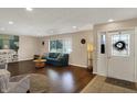 Bright living room with hardwood floors, a teal sofa, and decorative shelving at 4260 Springwood Trl, Indianapolis, IN 46228