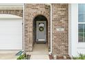 Charming entryway with a brick archway, featuring a decorative wreath and the house number at 52 E 286Th St, Atlanta, IN 46031