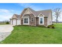 Brick home with a well-maintained lawn, showcasing a beautiful exterior and mature landscaping at 52 E 286Th St, Atlanta, IN 46031