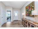 Inviting foyer with wood-look flooring and stylish console table with elegant decor at 5218 Pinehurst Ct, Whitestown, IN 46075