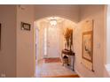 Bright entryway with tile floors, a chandelier, and an arched doorway at 5251 Ladywood Bluff Pl, Indianapolis, IN 46226