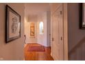 Hallway with hardwood floors, wall niches, and decorative artwork at 5251 Ladywood Bluff Pl, Indianapolis, IN 46226