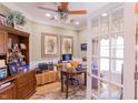 Well-lit home office with built-in shelves, french doors, and ample desk space at 5251 Ladywood Bluff Pl, Indianapolis, IN 46226