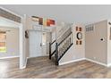 Inviting entryway with stylish decor, wood-look flooring, and a staircase with white and black railings at 5307 S State Road 135, Morgantown, IN 46160