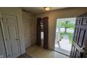 Inviting entryway with tile floor, features a coat closet and an open door to the outside at 5609 Sweet River Dr, Indianapolis, IN 46221