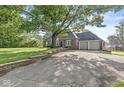 Brick home with a two-car garage and a large driveway at 5747 Allisonville Rd, Indianapolis, IN 46220