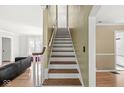 Interior view featuring a classic wooden staircase and hardwood floors at 5747 Allisonville Rd, Indianapolis, IN 46220