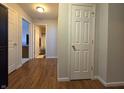 Inviting hallway with wood flooring, neutral walls, and access to several rooms at 5848 Jackie Ln, Indianapolis, IN 46221