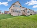 Expansive backyard featuring a large, well-maintained lawn with a home with a deck, and large windows at 6044 Shallow Crk Ln, Indianapolis, IN 46237