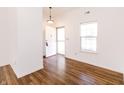 Bright entryway with hardwood floors and a freshly painted white front door at 6315 Hansbrough Way, Indianapolis, IN 46268