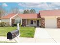 Single-story home featuring a lush green lawn, brick accents, and a mailbox at 6315 Hansbrough Way, Indianapolis, IN 46268