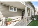 Covered front porch with a bench, potted plants, and brick-based pillars at 7092 Cherry Creek Blvd, Carmel, IN 46033