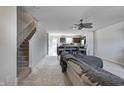 Open-concept living room featuring a staircase and seamless flow to a kitchen with barstool seating at 7195 E Rising Sun S Cir, Camby, IN 46113