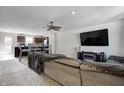 Inviting living room open to the kitchen with a comfortable sectional sofa and entertainment center at 7195 E Rising Sun S Cir, Camby, IN 46113