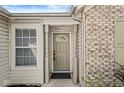 Close-up of a charming front door flanked by sidelight windows and brick detail, creating an inviting entrance at 7841 Whitaker Farms Ln, Indianapolis, IN 46237